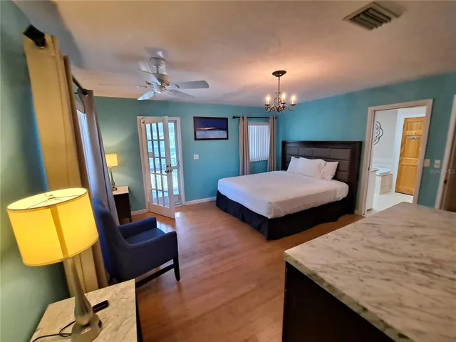 a bedroom with 2 bed table and chair