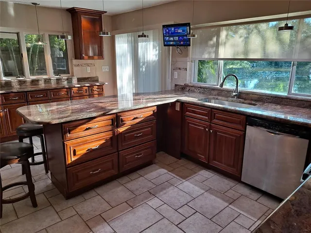 a kitchen with a sink and a large window