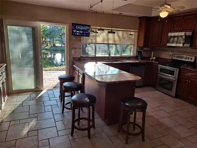 a kitchen with a sink a stove and a refrigerator