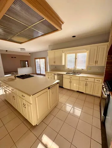 a spacious bathroom with a granite countertop sink toilet and mirror
