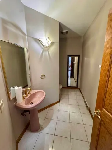 a bathroom with a toilet sink and window
