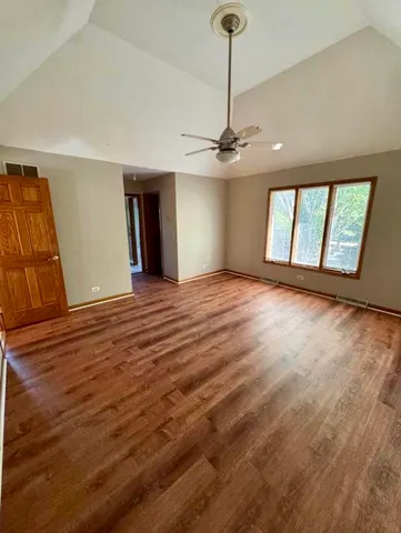 an empty room with windows and closet