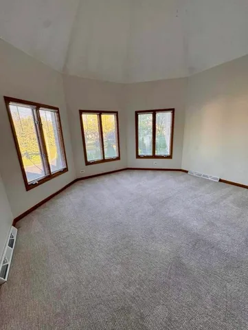 a spacious bathroom with a tub double vanity and mirror