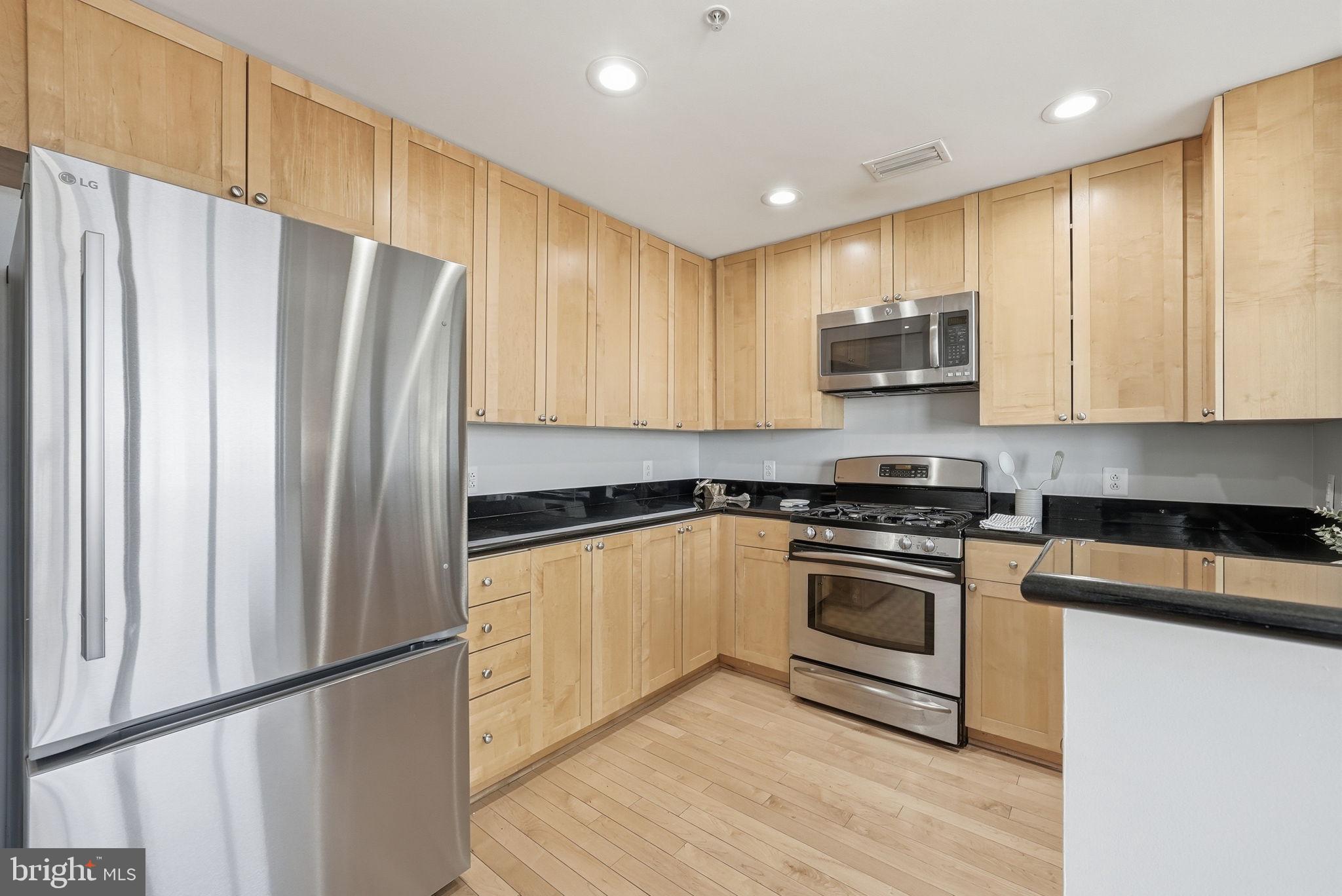 3650 South Glebe Road, Unit 1145 Arlington, VA 22202 - Photo 6 of 42 a kitchen with stainless steel appliances a refrigerator sink and microwave