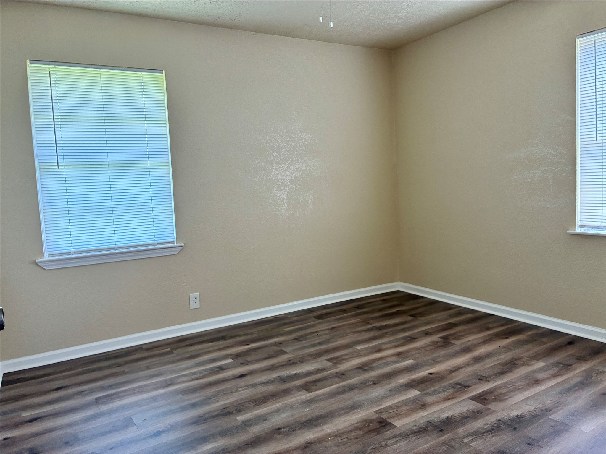 631 Roper Street Houston, TX 77034 - Photo 9 of 15 The second corner bedroom features fresh paint, new vinyl plank flooring, and a new ceiling fan.