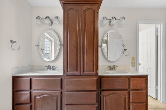 a bathroom with mirror and sink
