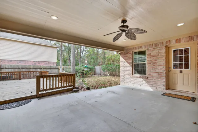 a view of a porch with wooden floor and iron fence