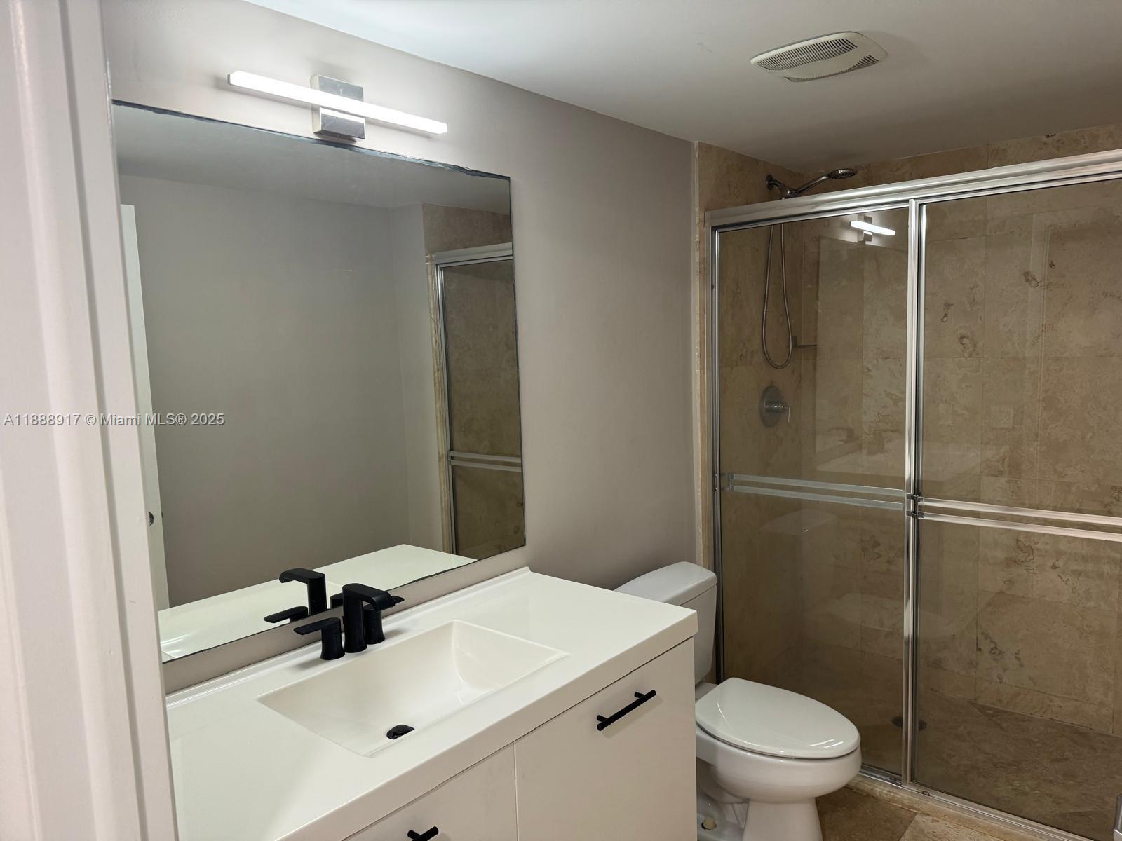 41 Southeast 5th Street, Unit 501 Miami, FL 33131 - Photo 11 of 36 a bathroom with a sink toilet and shower