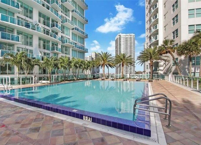 41 Southeast 5th Street, Unit 501 Miami, FL 33131 - Photo 5 of 36 a view of a swimming pool with a yard and plants