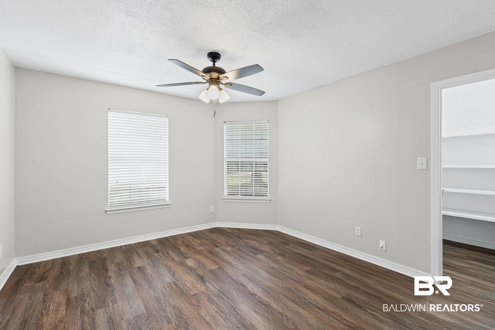 1301 Repoll Road Mobile, AL 36695 - Photo 14 of 21 Room featuring wood-finish flooring, light gray walls, and white baseboards