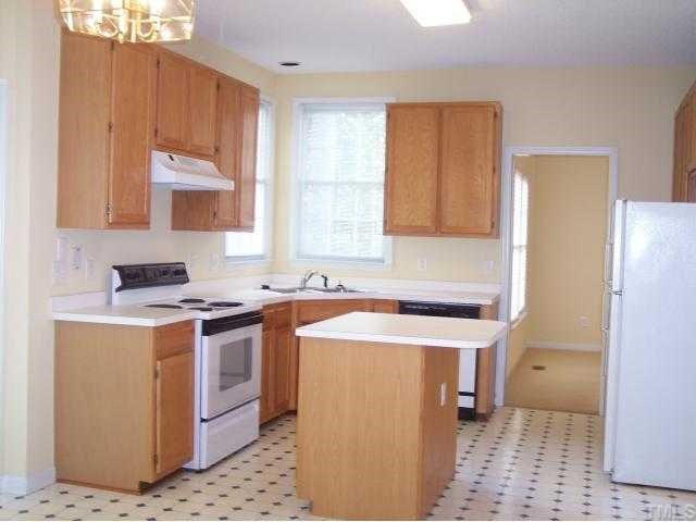 5154 Fairmead Circle Raleigh, NC 27613 - Photo 4 of 11 a kitchen with a sink stove and refrigerator