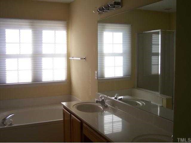 5154 Fairmead Circle Raleigh, NC 27613 - Photo 8 of 11 a bathroom with a sink and a bathtub