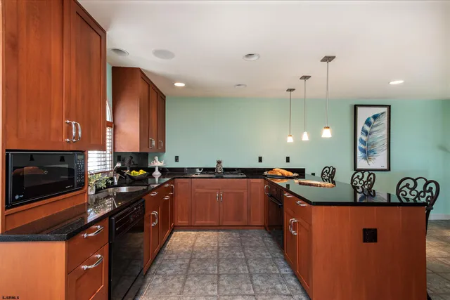 a kitchen with stainless steel appliances granite countertop a sink a stove and a refrigerator