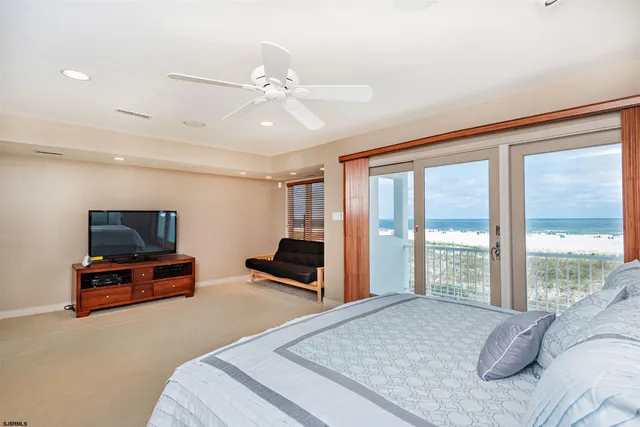 a bedroom with furniture and a flat screen tv