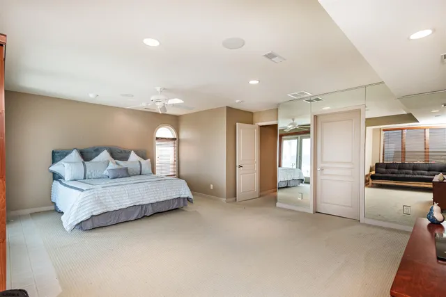 a spacious bedroom with a bed and a couch