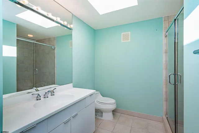 a bathroom with a sink and mirror with toilet
