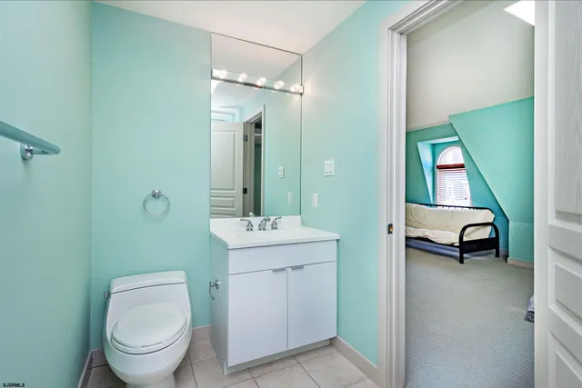 a bathroom with a toilet a sink and mirror