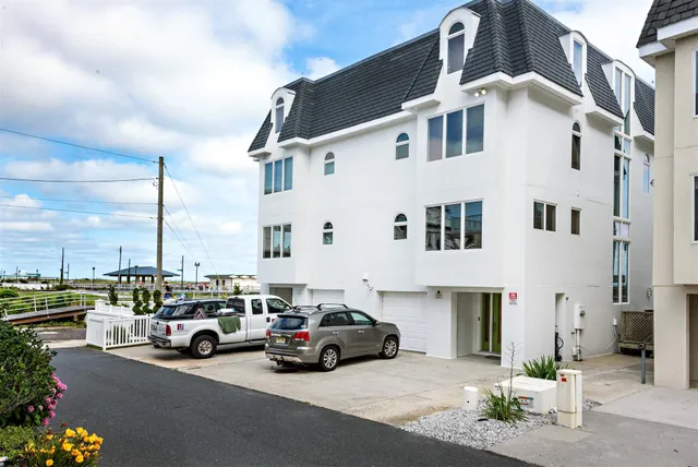 a car parked in front of a white building