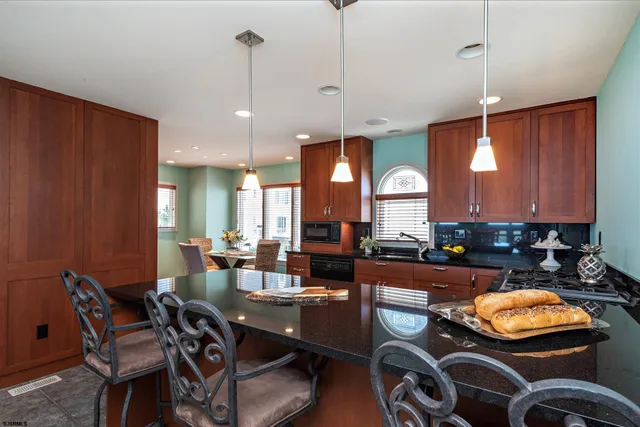a dining room filled chandelier and living room view