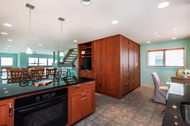 a kitchen with stainless steel appliances granite countertop a stove and a refrigerator