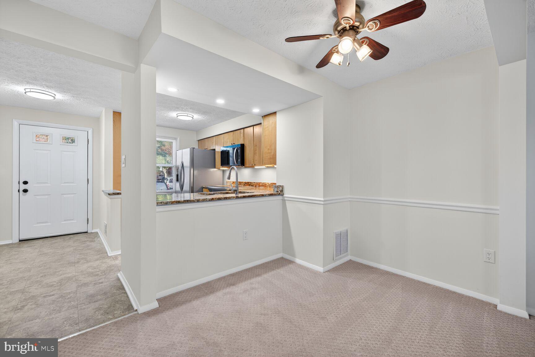 12515 Willow Spring Circle Germantown, MD 20874 - Photo 4 of 22 a view of a kitchen with a sink and cabinet area