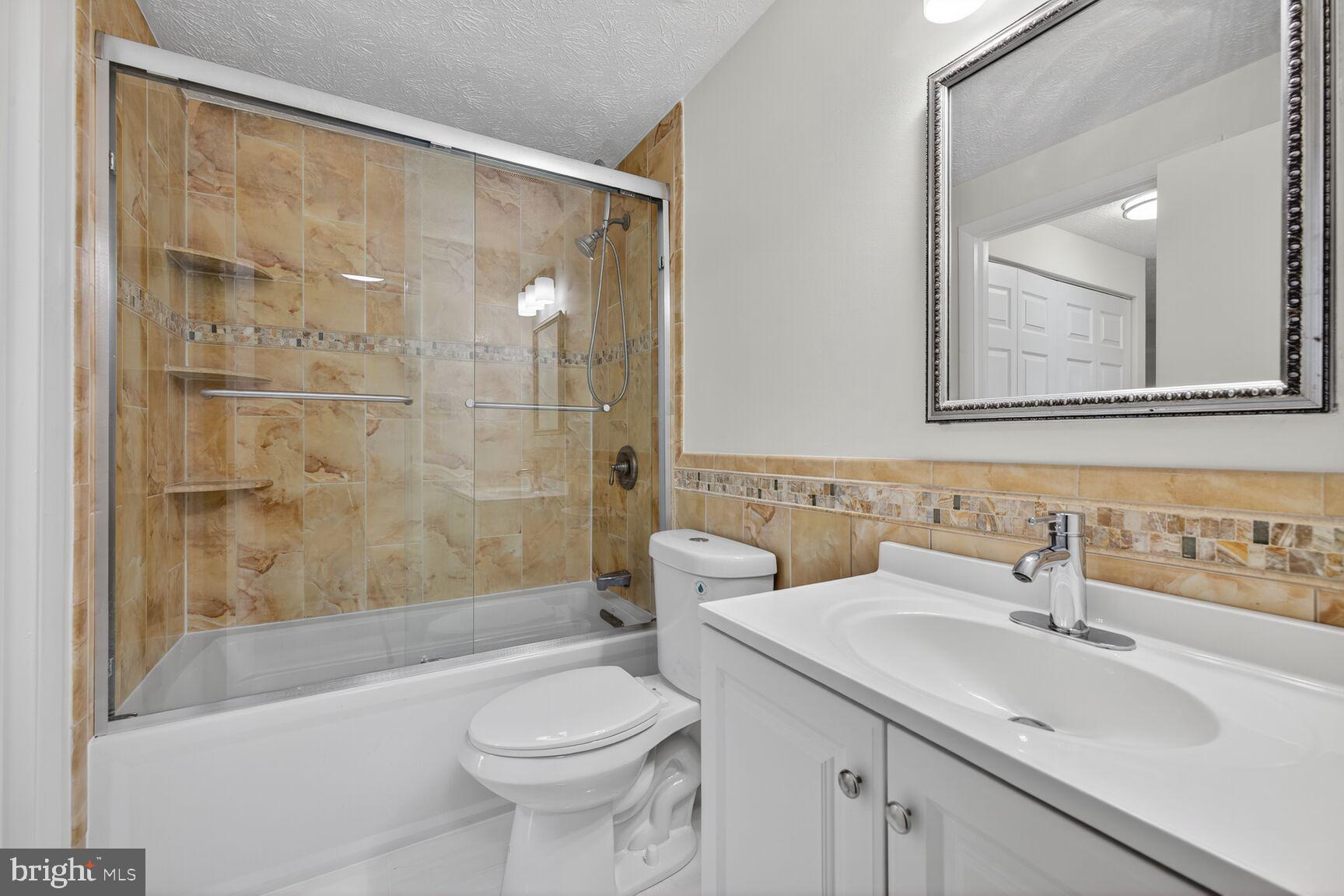 12515 Willow Spring Circle Germantown, MD 20874 - Photo 10 of 22 a bathroom with a sink a toilet and shower