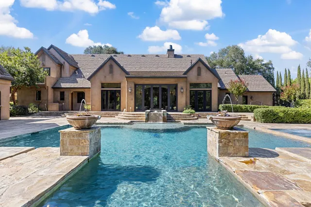 a view of a house with pool table and chairs