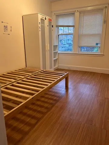 a view of a livingroom with wooden floor and a window