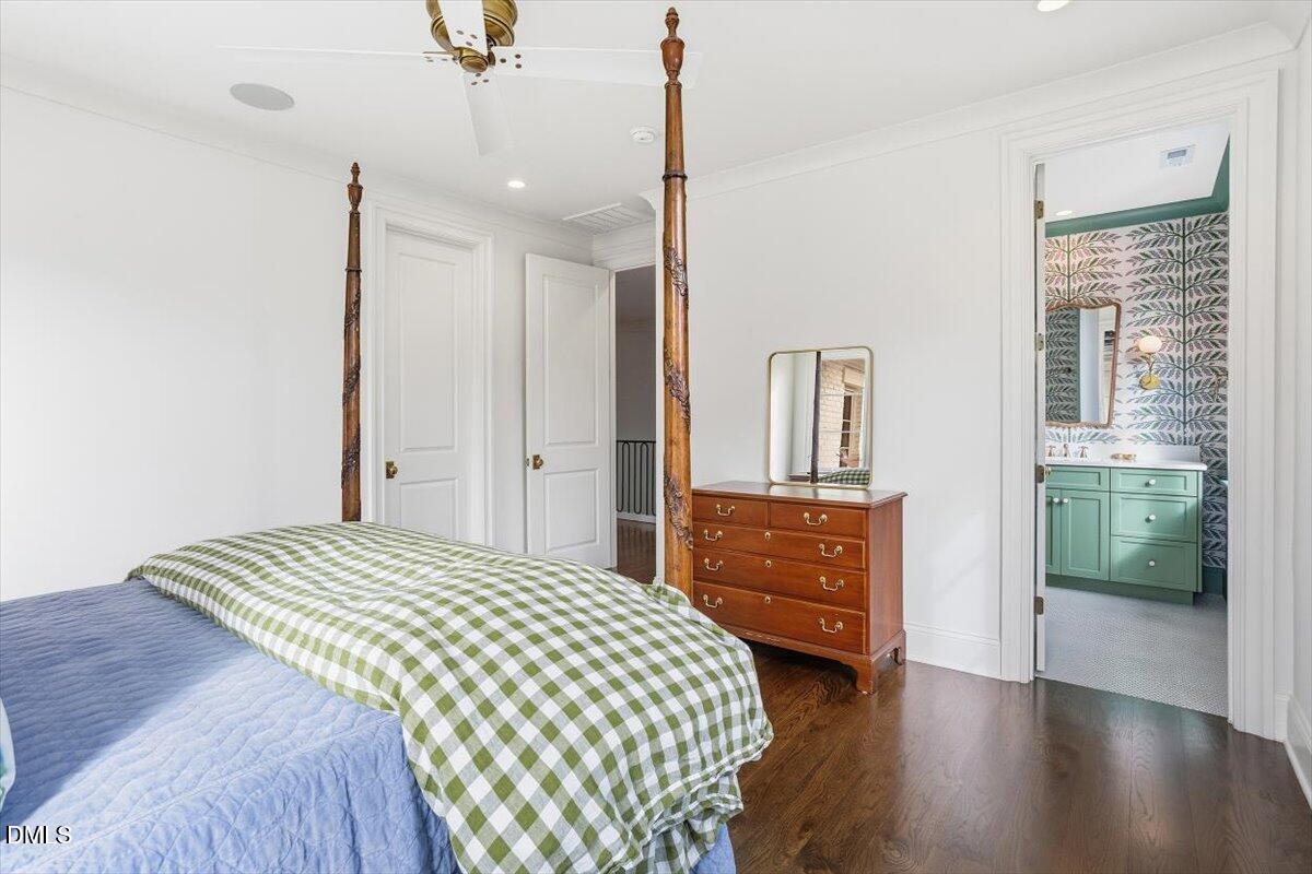 2123 St Marys Street Raleigh, NC 27608 - Photo 47 of 77 a bedroom with a bed and a dresser next to a window