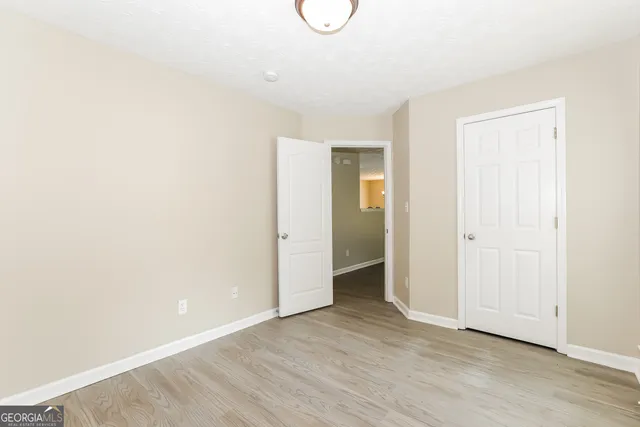 a view of room with wooden floor