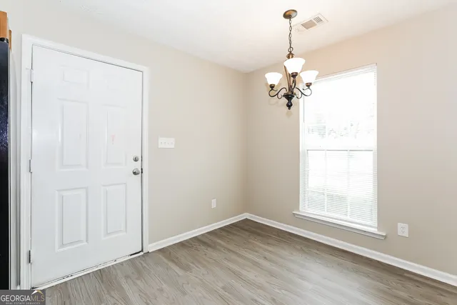 a view of a room with a window and a chandelier