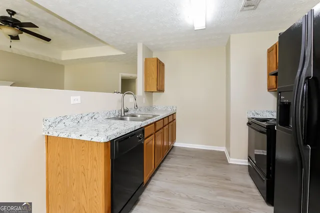 a bathroom with a granite countertop sink a mirror and a bathtub