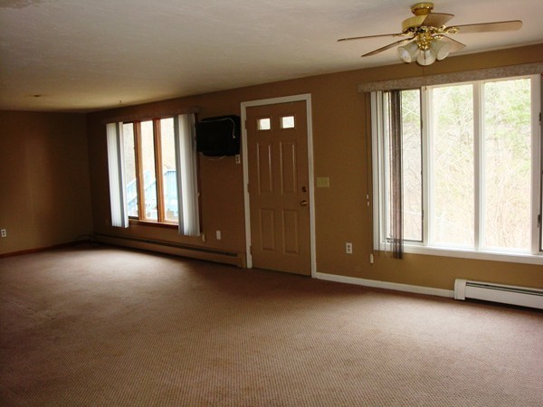 325 Torrey Road Southbridge, MA 01550 - Photo 4 of 25 an empty room with windows and chandelier fan