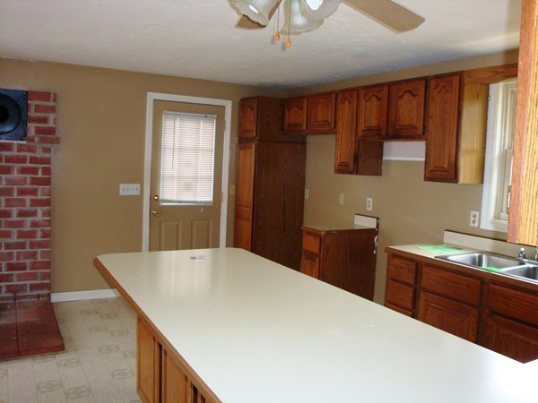 325 Torrey Road Southbridge, MA 01550 - Photo 6 of 25 a kitchen with a stove a sink and a refrigerator