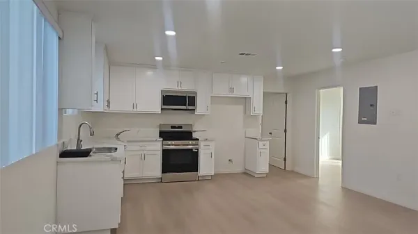 a kitchen with cabinets and stainless steel appliances