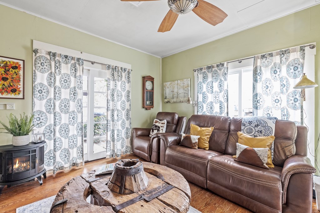 1447 Royal Oaks Loop Fredericksburg, TX 78624 - Photo 14 of 98 a living room with furniture and a fireplace
