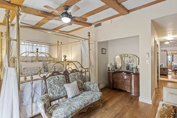 a view of a dining room with furniture a chandelier and wooden floor