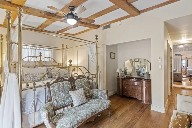 a view of a dining room with furniture a chandelier and wooden floor