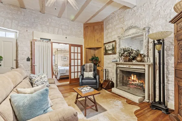 a living room with furniture a rug and a fireplace