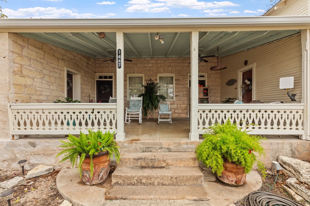 1447 Royal Oaks Loop Fredericksburg, TX 78624 - Photo 3 of 98 a potted plant sitting in front of a door
