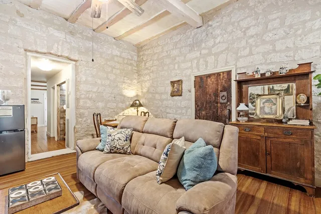 a room with furniture a flat screen tv and a dresser