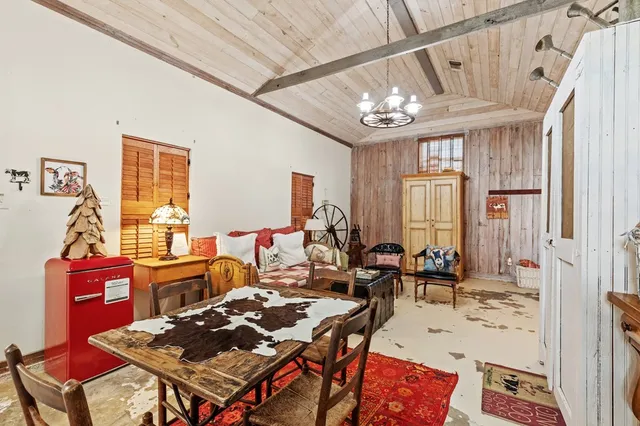 a view of a living room with furniture and a ceiling fan