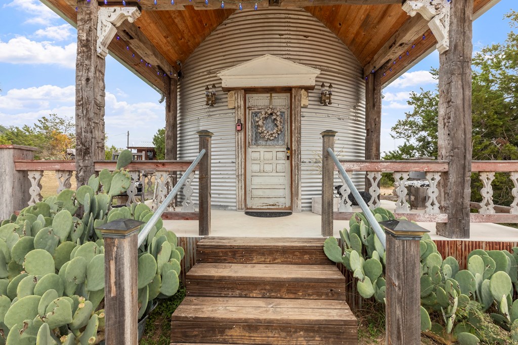 1447 Royal Oaks Loop Fredericksburg, TX 78624 - Photo 53 of 98 a front view of a house with outdoor seating and plants