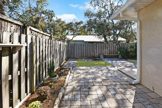 a view of a pathway with a wrought fence