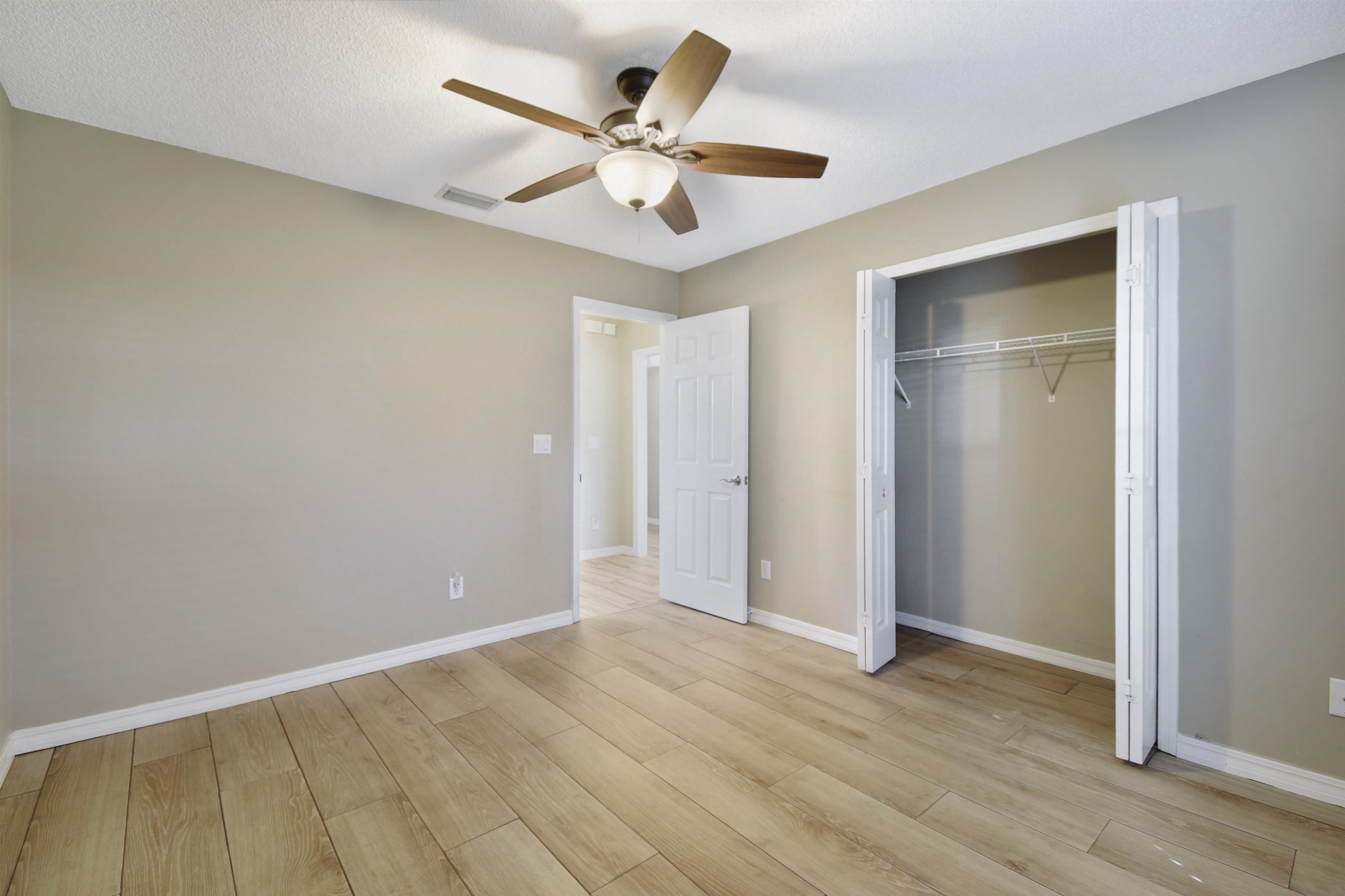 317 Mystical Way St. Augustine, FL 32080 - Photo 23 of 25 Unfurnished bedroom with ceiling fan, light wood-style flooring, and a closet