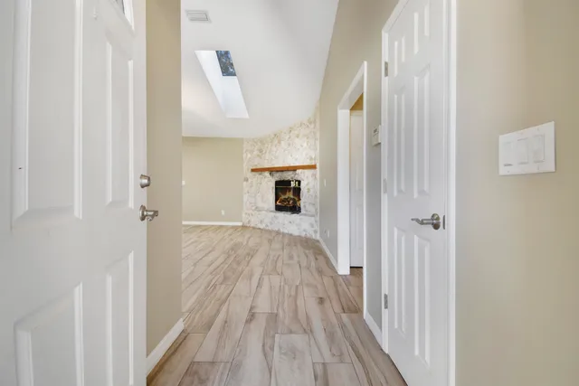 a view of a hallway view with wooden floor and staircase