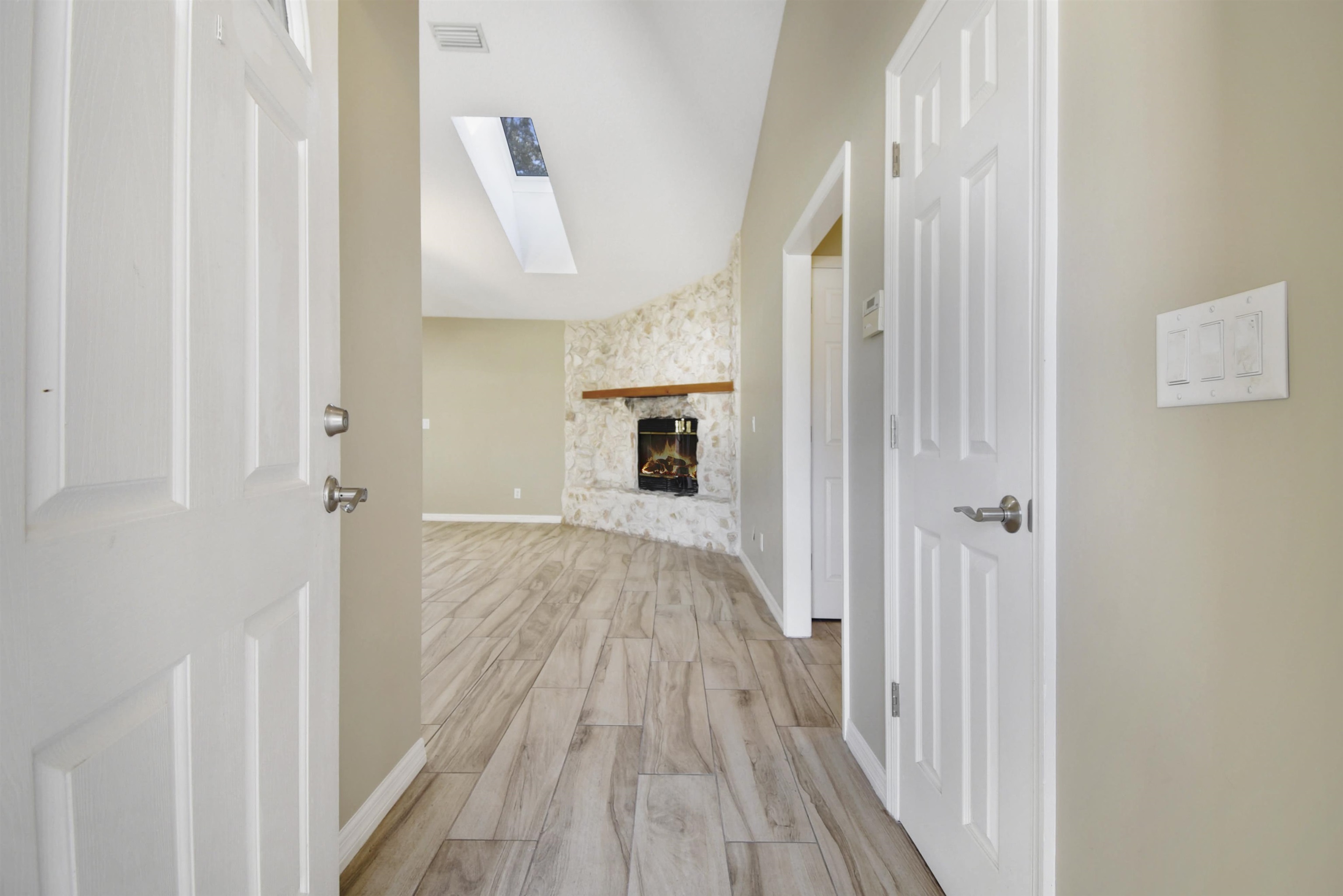 317 Mystical Way St. Augustine, FL 32080 - Photo 7 of 25 Hallway featuring a skylight and wood finish floors