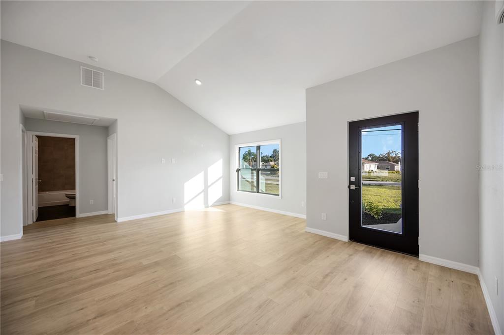 3294 West Price Boulevard North Port, FL 34286 - Photo 11 of 47 a view of an empty room with wooden floor and a window