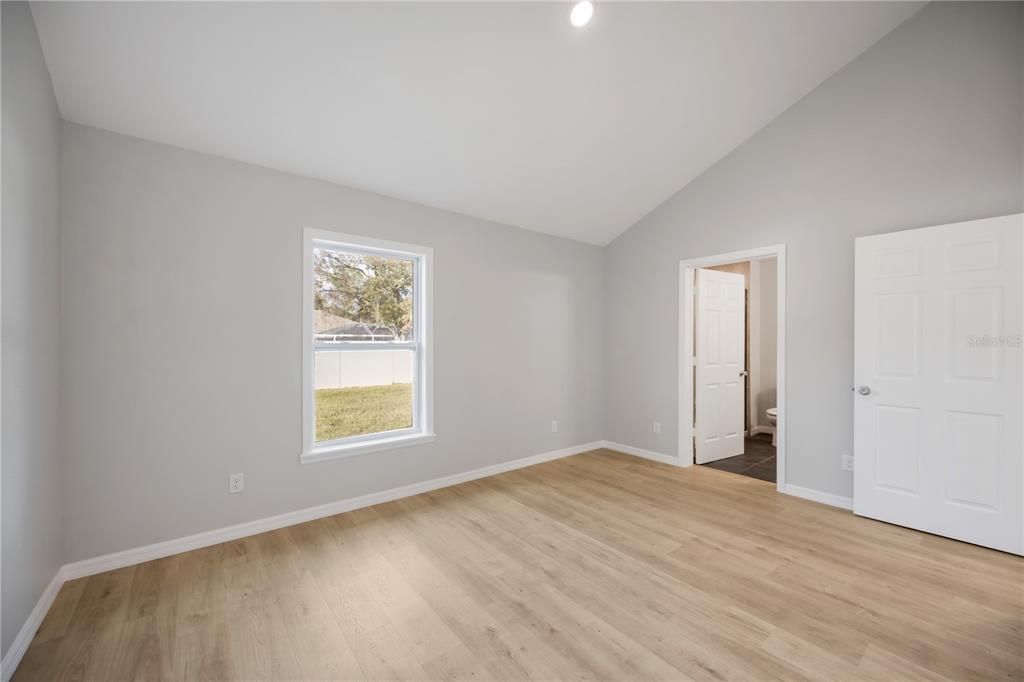 3294 West Price Boulevard North Port, FL 34286 - Photo 19 of 47 a view of an empty room with wooden floor and a window