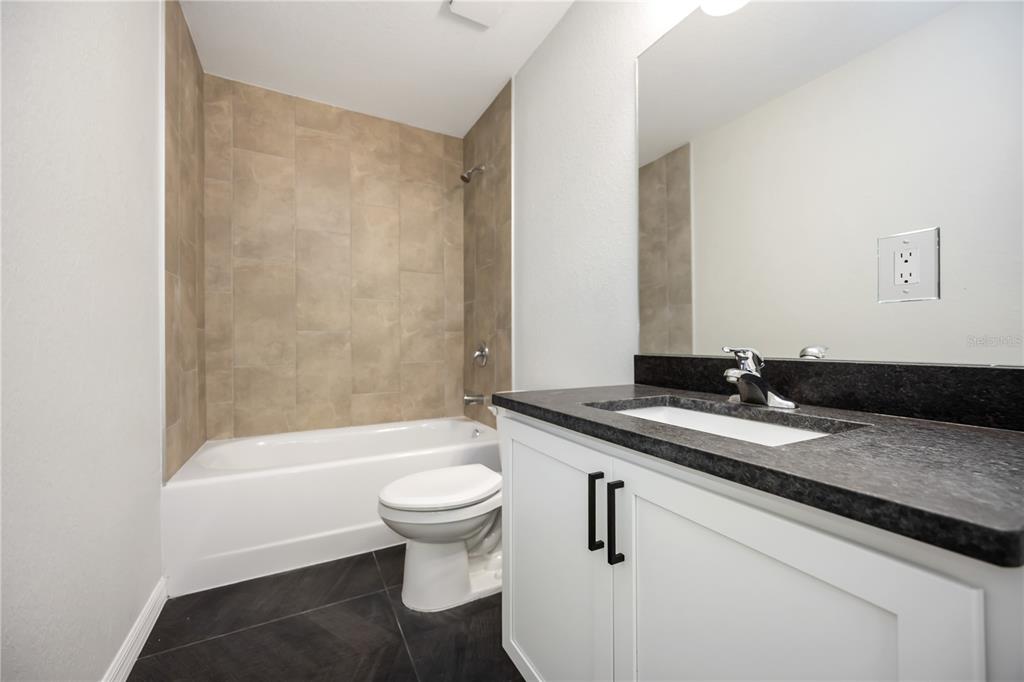 3294 West Price Boulevard North Port, FL 34286 - Photo 30 of 47 a bathroom with a sink and a mirror